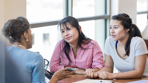 mother and daughter meet with a business professional