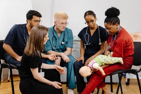 nursing students studying a dummy